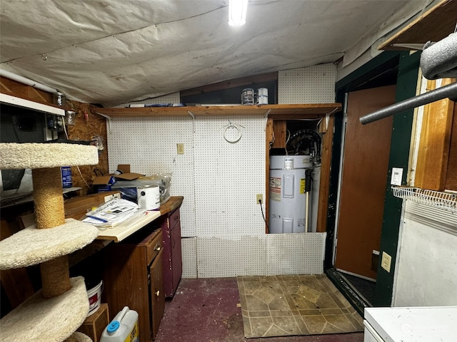 basement with a workshop area and electric water heater