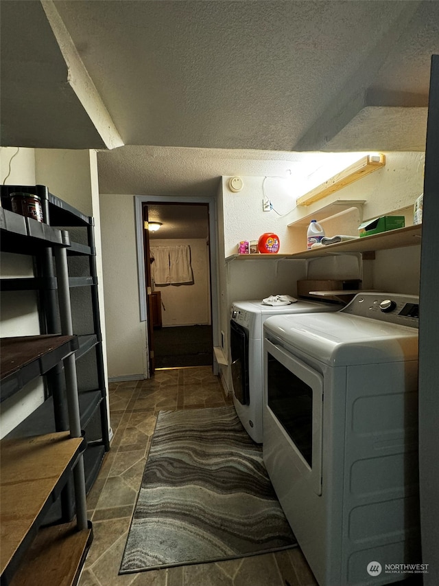 laundry area featuring a textured ceiling and separate washer and dryer