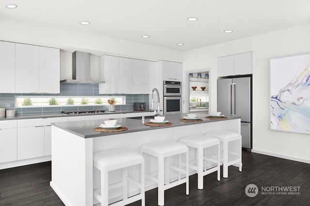 24218 118th Pl SE, Kent, WA 98030 - kitchen featuring stainless steel appliances, wall chimney range hood, modern cabinets, a sink, and dark wood-style flooring