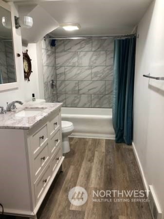 2142 Alki Ave SW Unit 1-5, Seattle, WA 98116 - full bathroom featuring shower / bath combo, hardwood / wood-style floors, vanity, and toilet