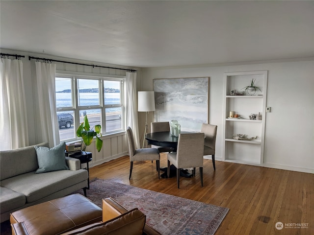 2142 Alki Ave SW Unit 1-5, Seattle, WA 98116 - dining space featuring built in shelves, wood-type flooring, and a water view