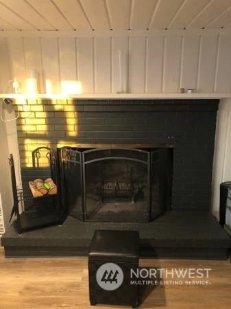 2142 Alki Ave SW Unit 1-5, Seattle, WA 98116 - interior details featuring hardwood / wood-style flooring and a brick fireplace
