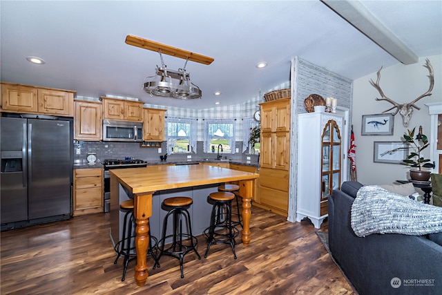 kitchen featuring wooden counters, stainless steel appliances, sink, dark hardwood / wood-style floors, and a kitchen island