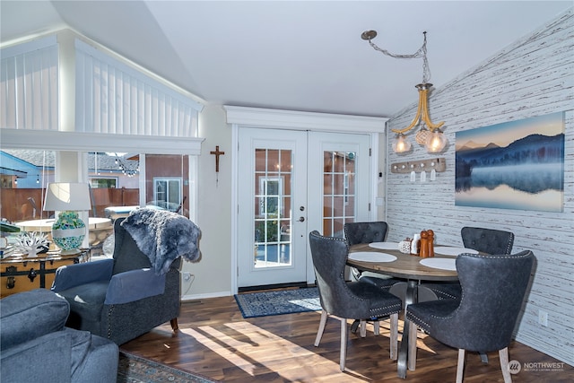 dining space featuring french doors, lofted ceiling, and wood-type flooring