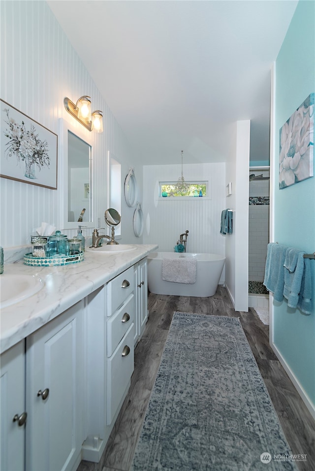 bathroom with wood-type flooring, vanity, and shower with separate bathtub