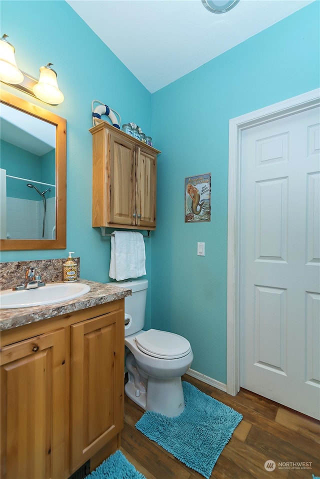 205 Fairway Pl SW, Mattawa, WA 99349 - bathroom with wood finished floors, vanity, toilet, and baseboards