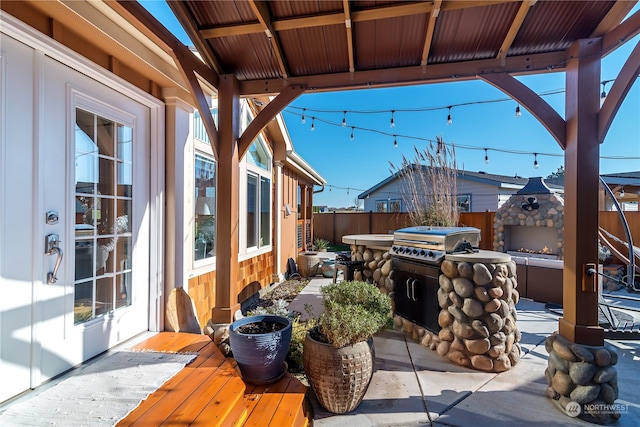 view of patio featuring area for grilling and a wooden deck