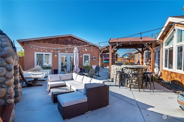 view of patio / terrace featuring an outdoor bar, outdoor lounge area, a gazebo, and french doors