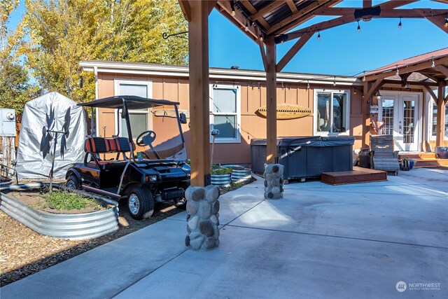 view of patio featuring a hot tub and french doors