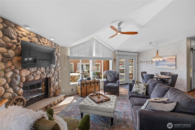 205 Fairway Pl SW, Mattawa, WA 99349 - living area with lofted ceiling, ceiling fan, a fireplace, wood finished floors, and a chandelier