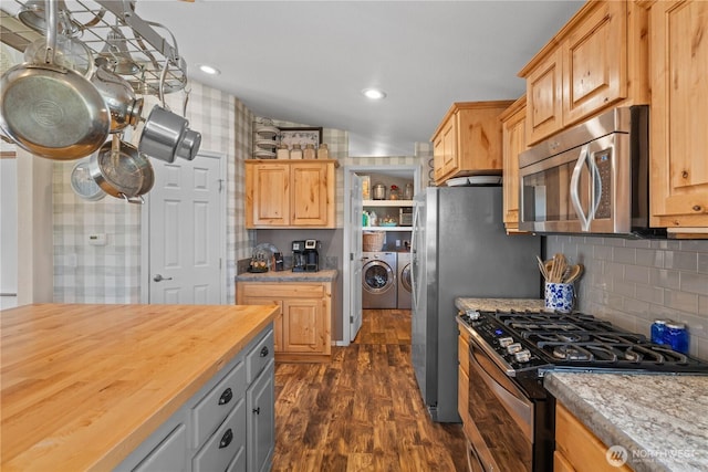 205 Fairway Pl SW, Mattawa, WA 99349 - kitchen featuring appliances with stainless steel finishes, washing machine and dryer, wood counters, dark wood-style flooring, and light brown cabinetry