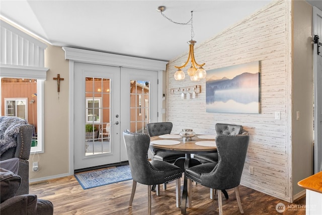 205 Fairway Pl SW, Mattawa, WA 99349 - dining space with wood finished floors, french doors, baseboards, lofted ceiling, and an accent wall