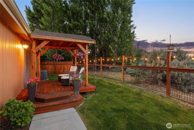 205 Fairway Pl SW, Mattawa, WA 99349 - yard at dusk featuring a wooden deck, central air condition unit, and a gazebo