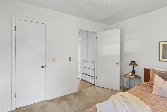 carpeted bedroom with a textured ceiling