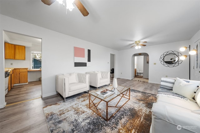 living room featuring hardwood / wood-style floors and ceiling fan