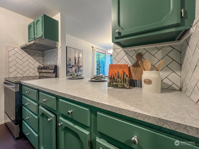 kitchen featuring stainless steel electric range, green cabinetry, exhaust hood, and backsplash