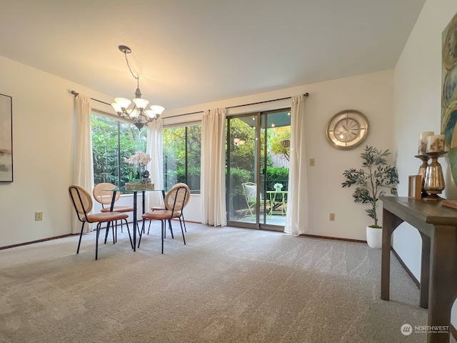 carpeted dining area with a chandelier