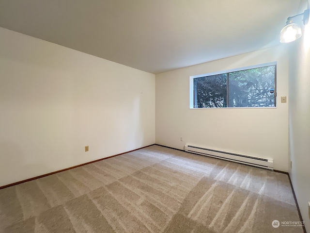 empty room featuring baseboard heating and light carpet