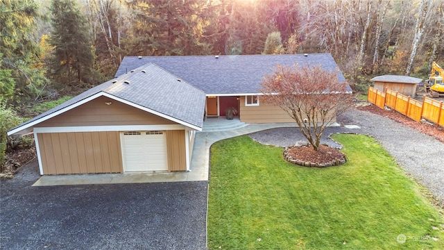 view of front of property featuring a garage and a front lawn