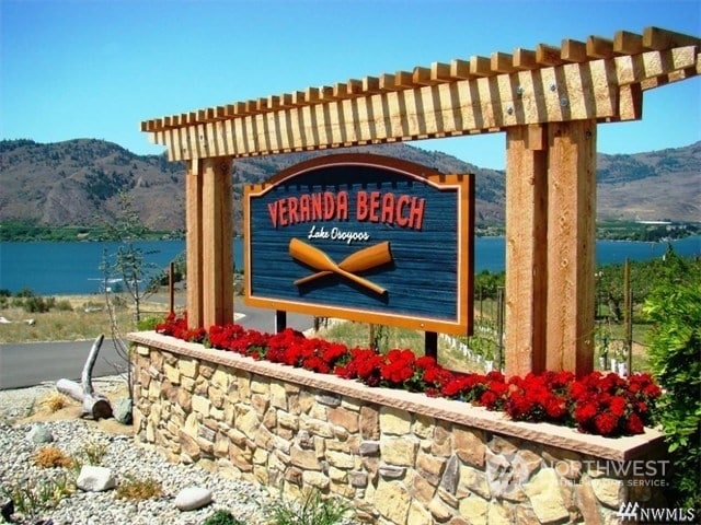 community / neighborhood sign featuring a water and mountain view