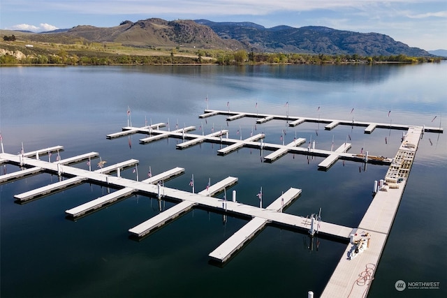 view of dock with a water and mountain view