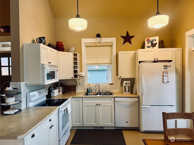 kitchen with hanging light fixtures, white cabinetry, sink, and white appliances