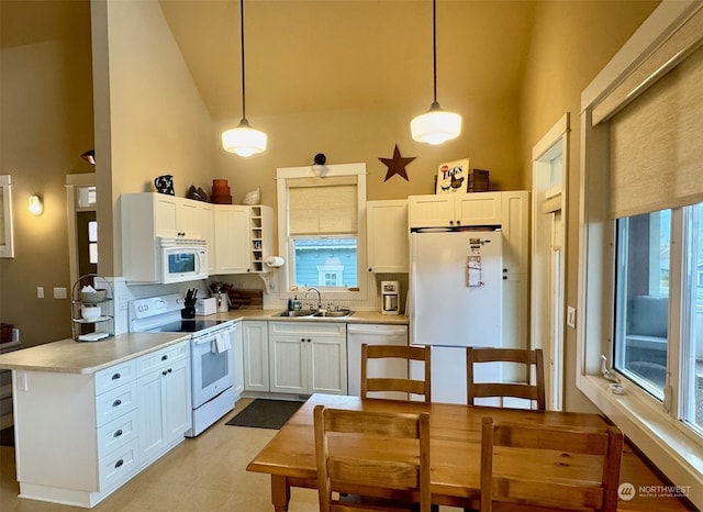 kitchen featuring sink, high vaulted ceiling, pendant lighting, white appliances, and white cabinets