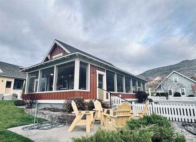 exterior space with a mountain view and a sunroom