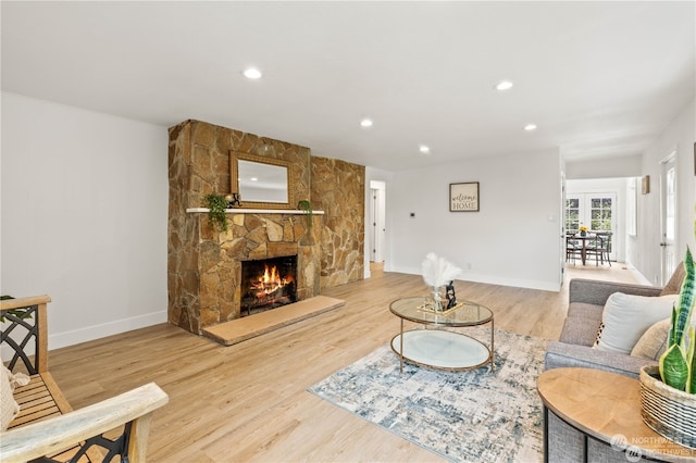 living room featuring a fireplace and light hardwood / wood-style flooring