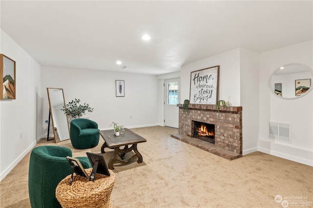 carpeted living room with a fireplace