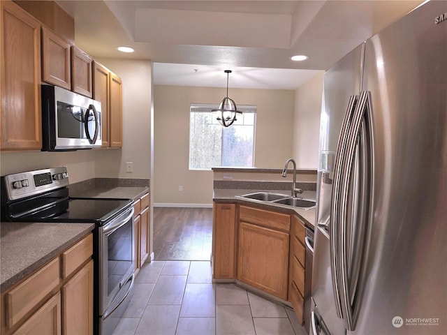 kitchen with sink, decorative light fixtures, appliances with stainless steel finishes, a notable chandelier, and light tile patterned flooring