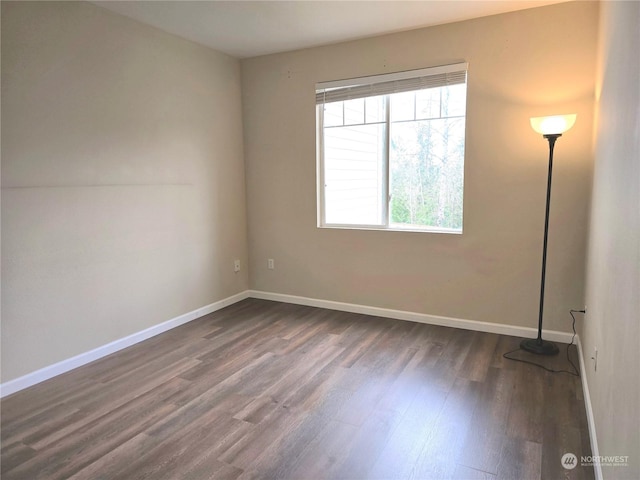 unfurnished room with dark hardwood / wood-style floors