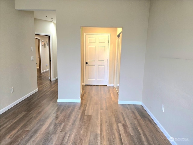 spare room featuring dark wood-type flooring