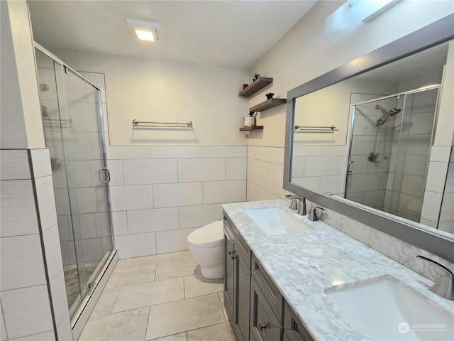 bathroom with toilet, tile patterned flooring, tile walls, and walk in shower