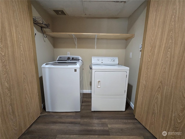 clothes washing area featuring washer and dryer and dark wood-type flooring