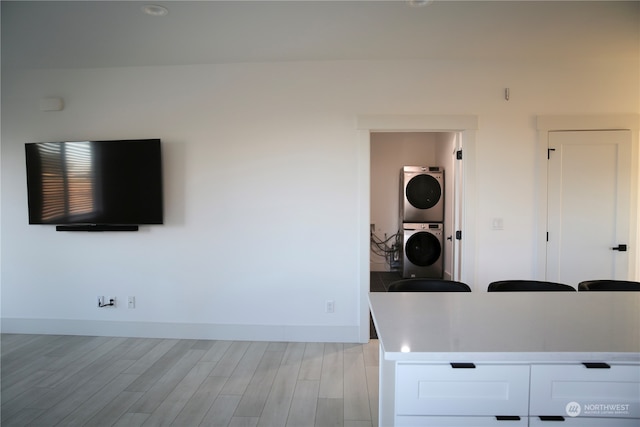 interior space featuring stacked washer and dryer and light hardwood / wood-style floors