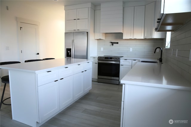 kitchen with white cabinetry, appliances with stainless steel finishes, and sink