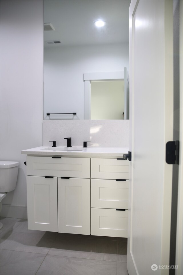 bathroom with vanity and toilet