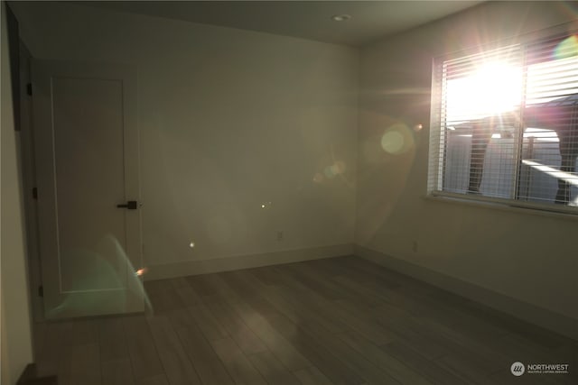 spare room with hardwood / wood-style flooring