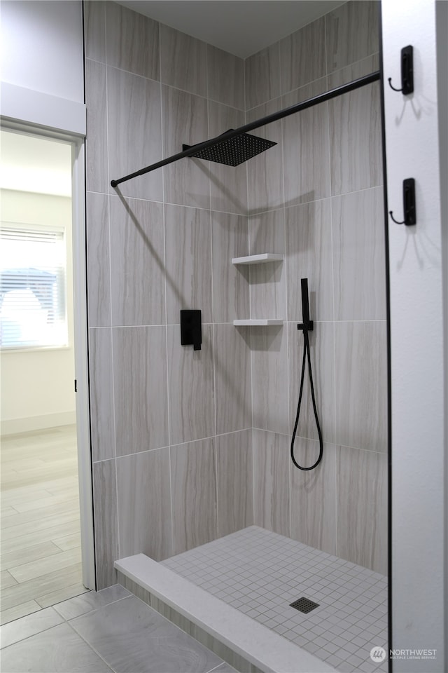 bathroom with tiled shower