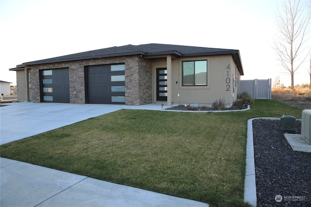 prairie-style home with a garage and a front yard