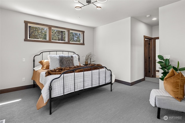 carpeted bedroom featuring an inviting chandelier