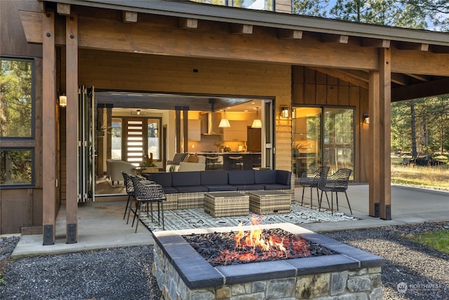 view of patio / terrace with an outdoor living space with a fire pit