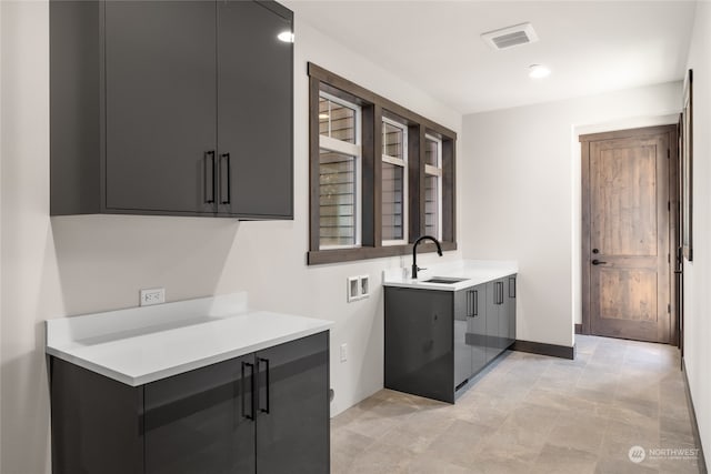 laundry room featuring cabinets, sink, and hookup for a washing machine