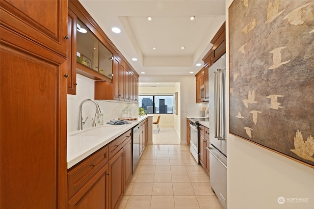 kitchen with appliances with stainless steel finishes, sink, and light tile patterned floors