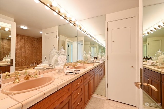 bathroom with vanity, a tub, and tile patterned flooring