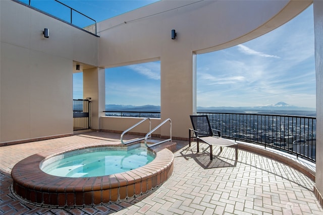 view of swimming pool with a water and mountain view, an in ground hot tub, and a patio area