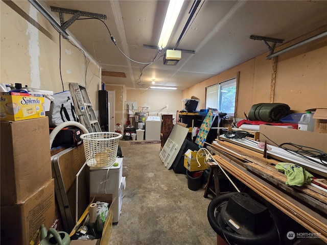 garage with washer / dryer and a garage door opener