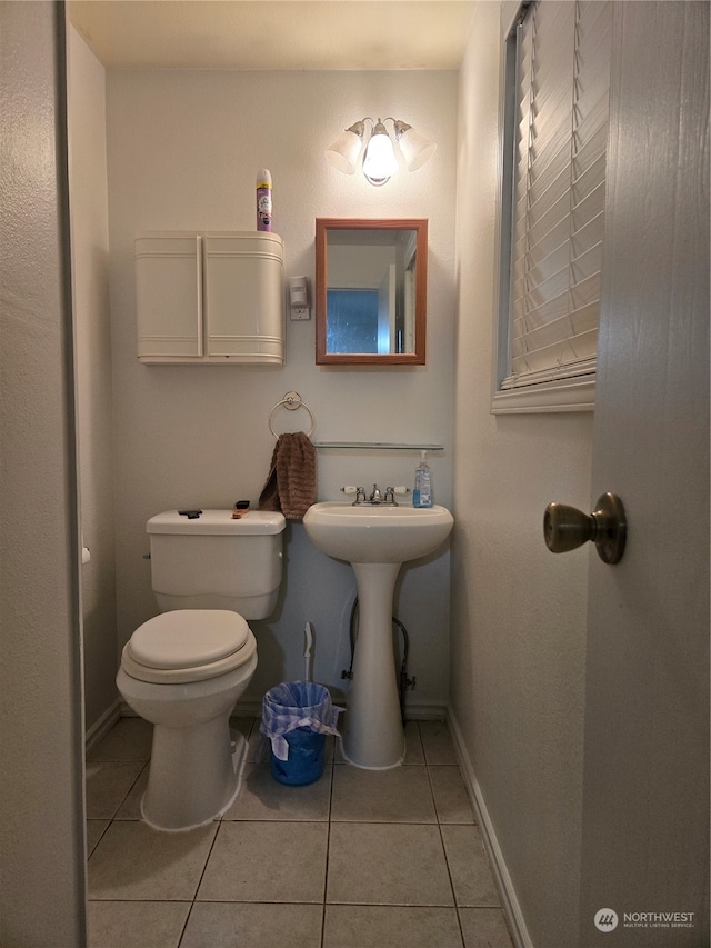 bathroom featuring tile patterned flooring, toilet, and sink