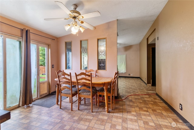 dining room with ceiling fan and lofted ceiling